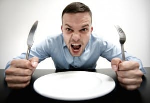 Man with utensils and Empty Plate Yelling